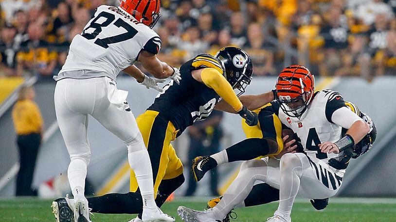 PITTSBURGH, PENNSYLVANIA - SEPTEMBER 30: Quarterback Andy Dalton #14 of the Cincinnati Bengals is tackled by the defense of the Pittsburgh Steelers during the game at Heinz Field on September 30, 2019 in Pittsburgh, Pennsylvania. (Photo by Justin K. Aller/Getty Images)