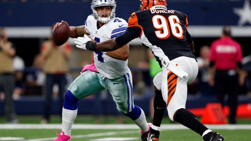 Bengals defensive end Carlos Dunlap draws a bead on Cowboys quarterback Dak Prescott in a game last season at AT&T Stadium in Arlington, Texas.