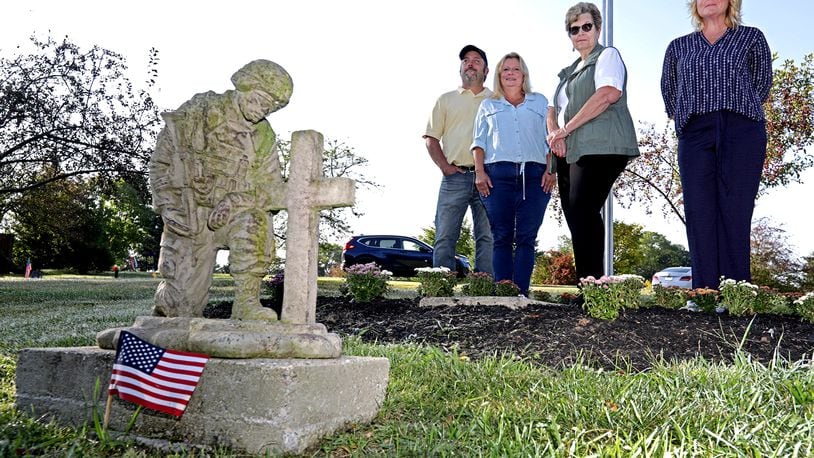 Posing for a picture at the Soldier's Mound at St. Bernard Cemetery are, from left, Wayne Woodruff and his wife, Trusie, the caretakers of the cemetery, Theresa Silvers, FCC Military Group Leader, and Betsy Van Hoose, Wreaths Across America Springfield Coordinator. BILL LACKEY/STAFF