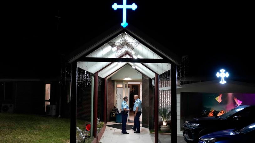 Security officers stand guard outside Orthodox Assyrian church in Sydney, Australia, Monday, April 15, 2024. Police in Australia say a man has been arrested after a bishop and churchgoers were stabbed in the church. There are no life-threatening injuries. (AP Photo/Mark Baker)