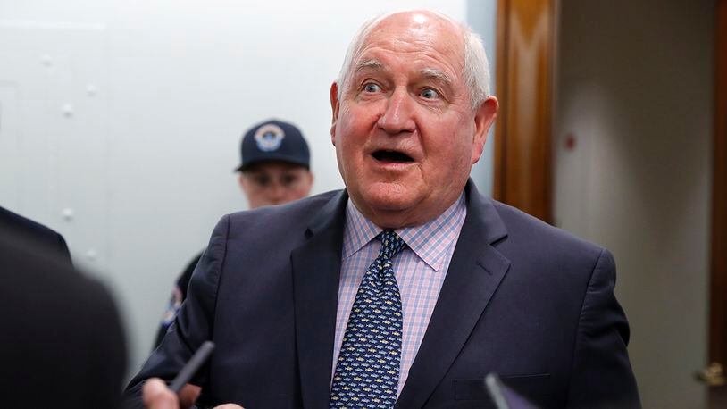 In this April 11, 2018, file photo, Agriculture Secretary Sonny Perdue speaks with reporters on Capitol Hill in Washington. The Trump administration is setting out to accomplish what this year's farm bill didn't: Tighten work requirements for millions of Americans who receive federal food assistance.