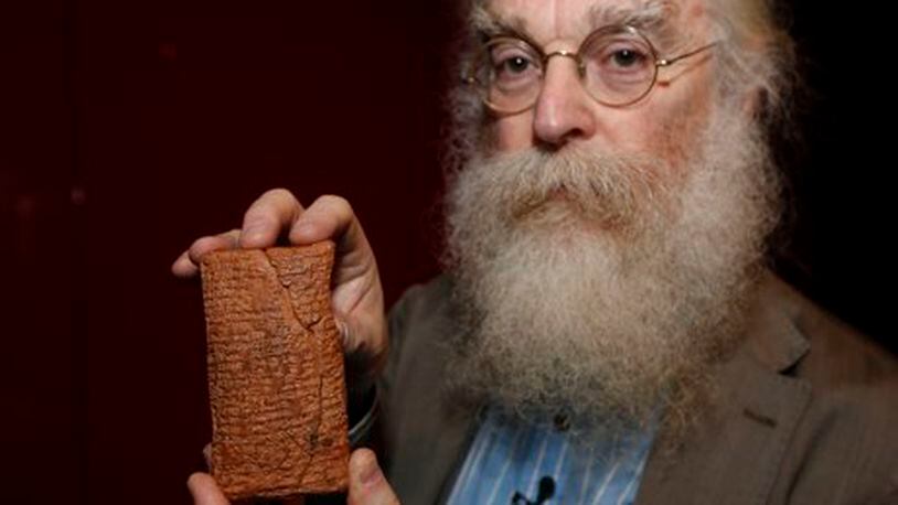 Irving Finkel with the cuneiform clay tablet at the British Museum. Photograph: Sang Tan/AP