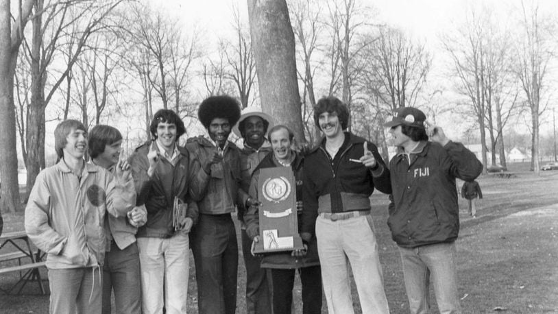 Wittenberg’s Larry Hunter holds the 1977 national championship photo and poses for a photo with players, including Brian Agler, far left, in Springfield. Wittenberg photo