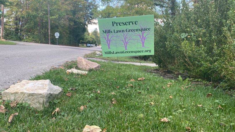 A yard sign reads, "Preserve Mills Lawn greenspace" in Yellow Springs. The sign refers to the lawn and trees behind Mills Lawn Elementary School in Yellow Springs. The controversy over what to do with the small green area behind Mills Lawn Elementary School has affected people across Yellow Springs. Eileen McClory / staff