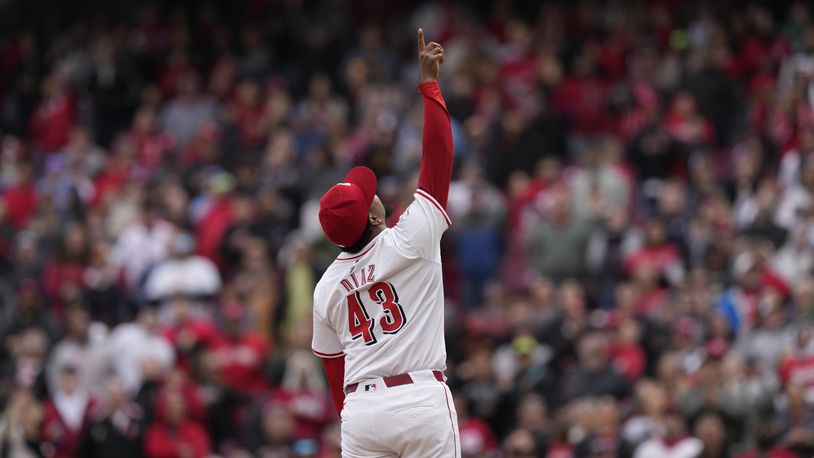 Cincinnati Reds pitcher Alexis Díaz points to a pop fly hit by Los Angeles Angels' Mickey Moniak in the ninth inning of a baseball game Sunday, April 21, 2024, in Cincinnati. Reds second baseman Santiago Espinal caught the ball for the third out. (AP Photo/Carolyn Kaster)