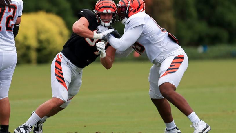 Cincinnati Bengals' Sam Hubbard, left, rushes against Bobby Hart, right, during NFL football camp in Cincinnati, Tuesday, Aug. 18, 2020. (AP Photo/Aaron Doster)