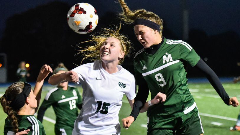Badin’s Gabby Riesing (15) and McNicholas’ Mackenzie Burdick (9) battle for the ball during their Division II sectional final soccer game Monday, Oct. 23 at Winton Woods High School. Badin advances with a 2-1 win. NICK GRAHAM/STAFF