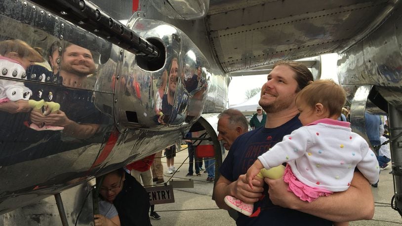 Brad Chandler looks over a B-25 aircraft with 18-month-old daughter Emery during Saturday’s 75th anniversary celebration of the 1942 Doolittle Raid over Tokyo at Grimes Field. BRETT TURNER / CONTRIBUTED