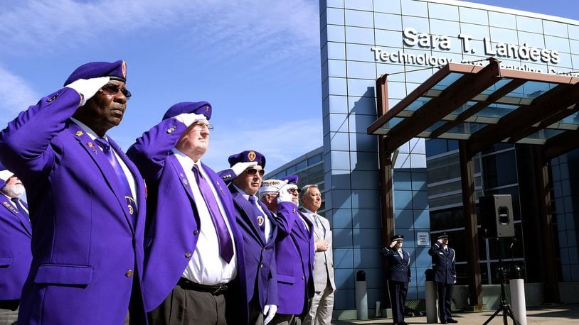 Members of the Military Order of the Purple Heart salute as “Taps” is played during a ceremony in 2015 designating Clark State Community College as a Purple Heart Campus. Clark State is the first college in the state to receive the designation. Bill Lackey/Staff