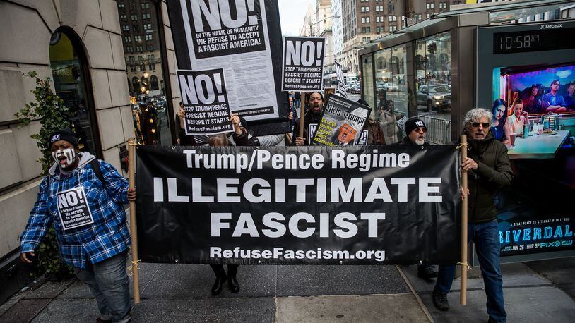 NEW YORK, NY - JANUARY 11: A small group of anti-Donald Trump protestors marches on 5th Avenue toward Trump Tower, January 11, 2017 in New York City. On Wednesday morning, Trump is having his first press conference since winning the election. (Photo by Drew Angerer/Getty Images)