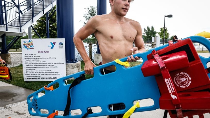 Head lifeguard at the Kroger Aquatic Center in Huber Heights, Tyler Gould goes through training exercises before the pool opens Friday June 23, 2023. JIM NOELKER/STAFF