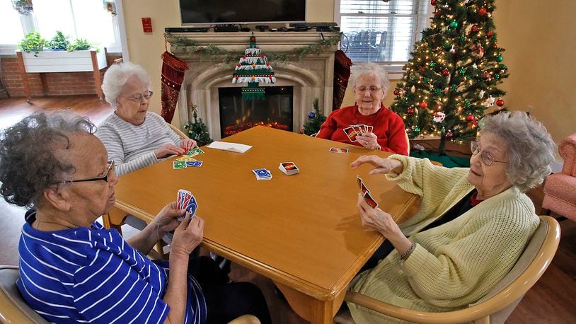 Residents of Clark Memorial Home, from left, Anna Odessa Clayborne, Florence Shinkle Phyllis Peck and NormaChrisman play cards in the Activity Room at the facility Wednesday, Dec. 6, 2023. BILL LACKEY/STAFF