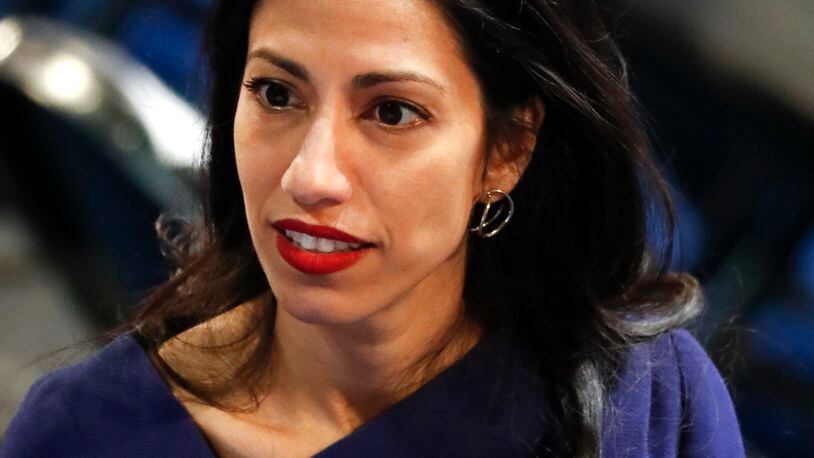 Huma Abedin, an aide to Democratic presidential candidate Hillary Clinton, talks on the floor of the Democratic National Convention in Philadelphia, Tuesday, July 26, 2016. (AP Photo/Paul Sancya)