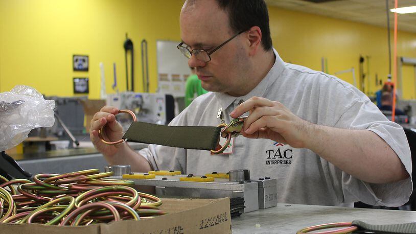 TAC Industries Inc employee Brian Golen puts parts together that will become cargo netting for the United States Air force. JEFF GUERINI/STAFF