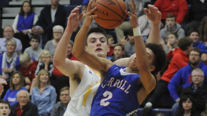 Carroll’s Eli Ramsey snaps a rebound away from Alter’s Dominic Laravie. Carroll upset Alter 53-42 in a boys high school basketball D-II sectional semifinal at Fairmont’s Trent Arena on Wednesday, March 1, 2017. MARC PENDLETON / STAFF