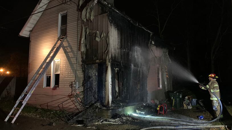 Fire heavily damaged a two-story house on Weimer Street Friday evening, Nov. 20, 2020, in Springfield. BILL LACKEY/STAFF
