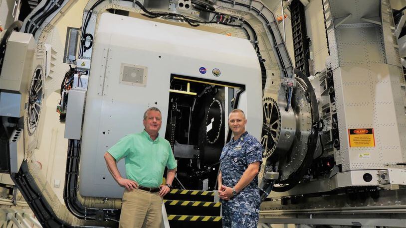 Naval Medical Research Unit Dayton (NAMRU-Dayton) research psychologist Henry Williams (left), and Capt. Richard Folga (right), Naval aerospace and operational physiologist near the Disorientation Research Device (DRD). The DRD, sometimes called the "Kraken," is a one-of-a kind Navy aerospace medicine research device. Navy photo