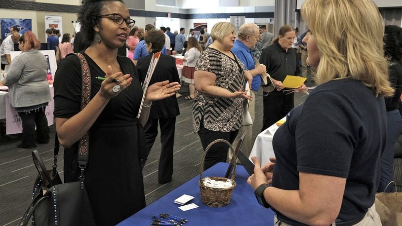 This file photo shows an exchange at a job fair held in Clark County in 2017. A virtual career fair will be held this month and will be centered around companies in Clark and Greene counties. Bill Lackey/Staff