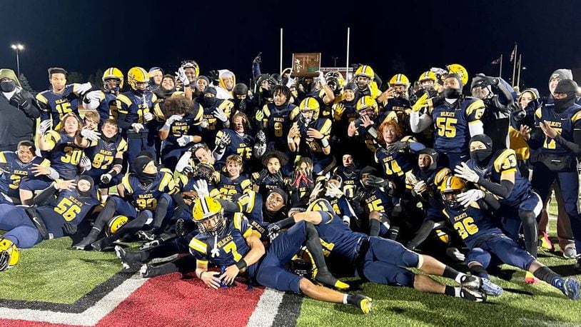 The Springfield High School football team poses for a photo with the Division I, Region 2 championship trophy after defeating Olentangy Liberty 35-7 on Friday night at London's Bowlus Field. CONTRIBUTED PHOTO BY MICHAEL COOPER