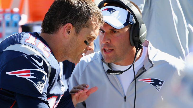 Josh McDaniels, offensive coordinator for the New England Patriots congratulates Tom Brady #12 of the New England Patriots after his 400th career touchdown pass during the first half against the Jacksonville Jaguars at Gillette Stadium on September 27, 2015 in Foxboro, Massachusetts. (Photo by Maddie Meyer/Getty Images)