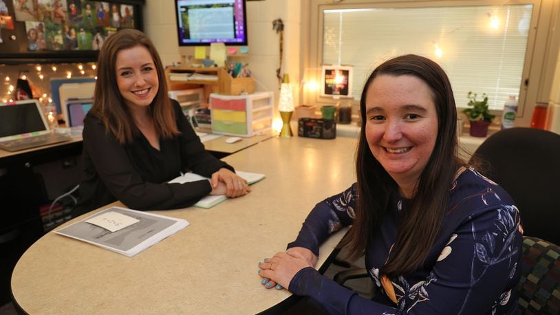 Meagan Wagner, school counselor at Tecumseh Middle School, and Allyson Crook, a mental health therapist, in Wagner's office at the school. BILL LACKEY/STAFF