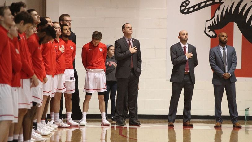 Wittenberg coach Matt Croci, center, stands for the national anthem before a game against Wabash on Wednesday, Feb. 13, 2019, at Pam Evans Smith Arena in Springfield. David Jablonski/Staff