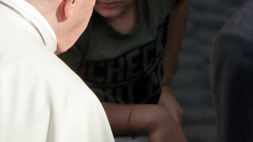 Pope Francis has his hands sanitized by his personal assistant during his weekly general audience general audience in San Damaso courtyard at the Vatican, Wednesday, Sept. 9, 2020. (AP Photo/Andrew Medichini)