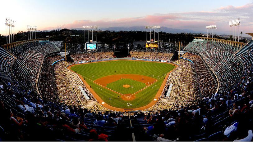 A wide angle view of the Los Angeles Dodgers Stadium as the Station fires burn in the distance on August 31, 2009 in Los Angeles, California. The family of a woman who died after a foul ball struck her in the head at Dodgers Stadium on Aug. 25, 2018 is calling for baseball stadiums across the country to improve safety measures for fans.
