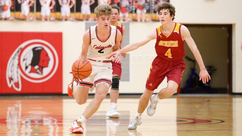 Cedarville High School senior Trent Koning drives past Northeastern's Sam Franzen during their game on Tuesday night in Cedarville. CONTRIBUTED PHOTO BY MICHAEL COOPER