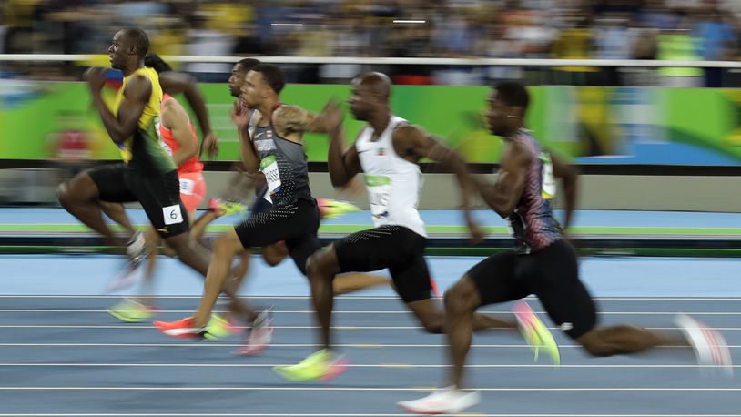 Jamaica's Usain Bolt, left, takes the lead in a men's 100-meter semifinal during the athletics competitions of the 2016 Summer Olympics at the Olympic stadium in Rio de Janeiro, Brazil, Sunday, Aug. 14, 2016. (AP Photo/Matt Dunham)