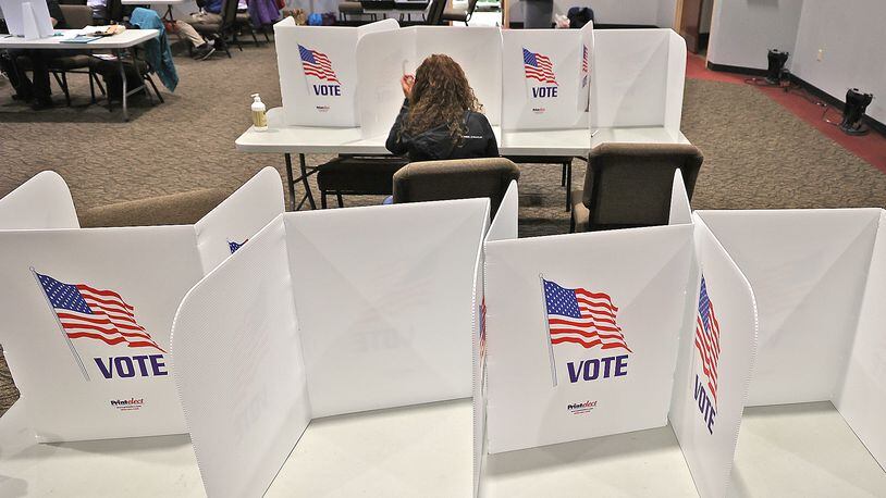 A woman casts her vote at Church on Middle Urbana Road in Clark County. BILL LACKEY/STAFF