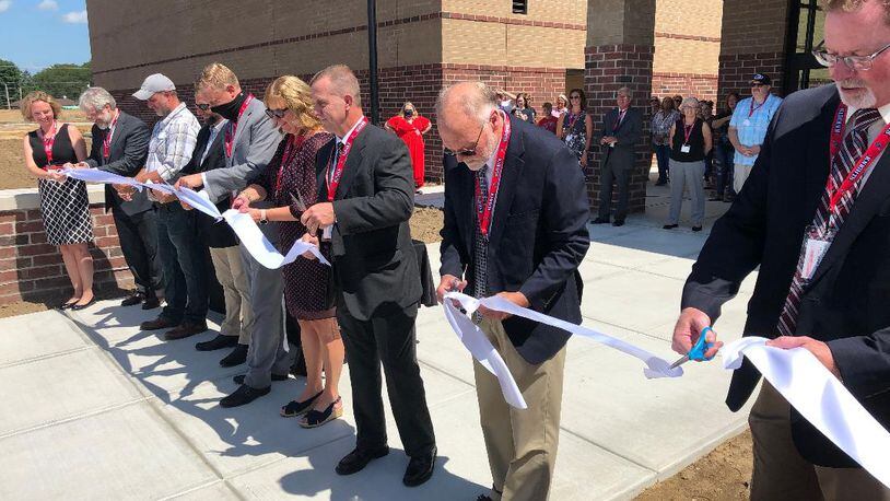 Greenon Local School Districts Board of Education is conducting interviews for a new treasurer. Here, board members and others cut the ribbon last month when they officially welcomed crowds to Greenon Schools' new K-12 campus. Photo by Brett Turner
