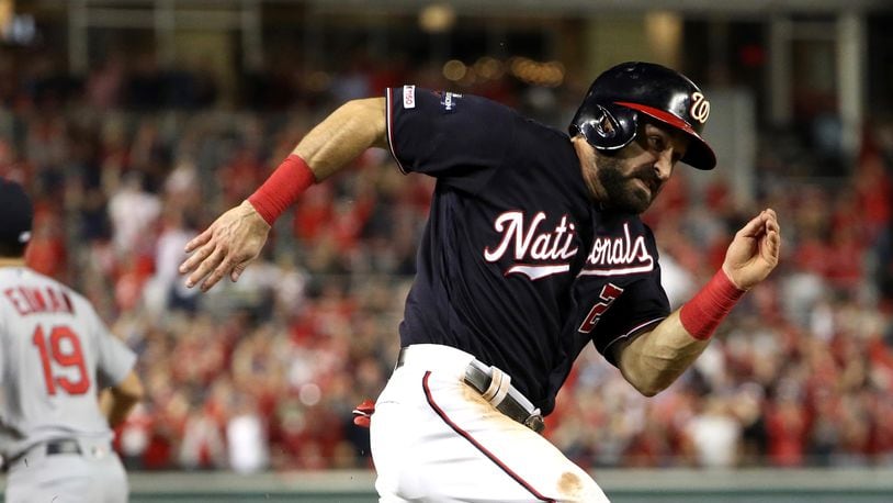 The Nationals' Adam Eaton runs home to score during the third inning of game three of the National League Championship Series against the St. Louis Cardinals at Nationals Park on October 14, 2019 in Washington, DC. (Photo by Patrick Smith/Getty Images)