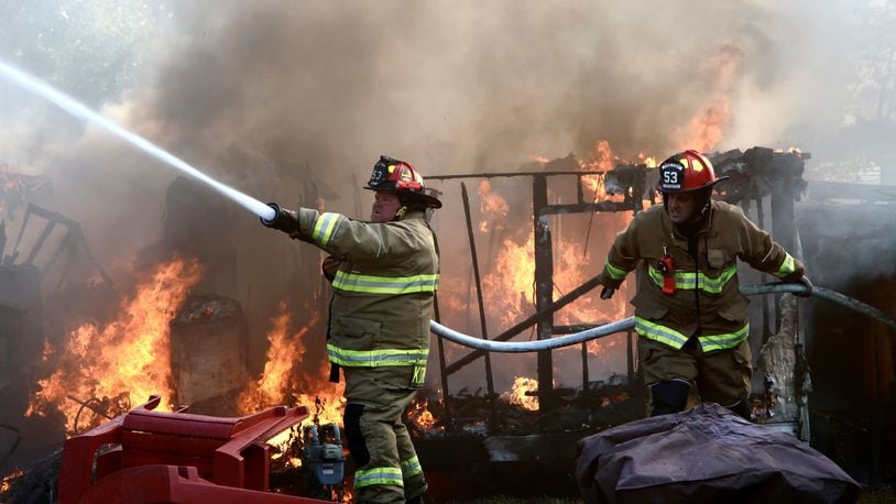 Firefighters from three local departments battled a fire that involved six mobile homes Wednesday, Sept. 20, 2023, on Marquart Road at Ohio 235 in Pike Twp., Clark County. BILL LACKEY/STAFF
