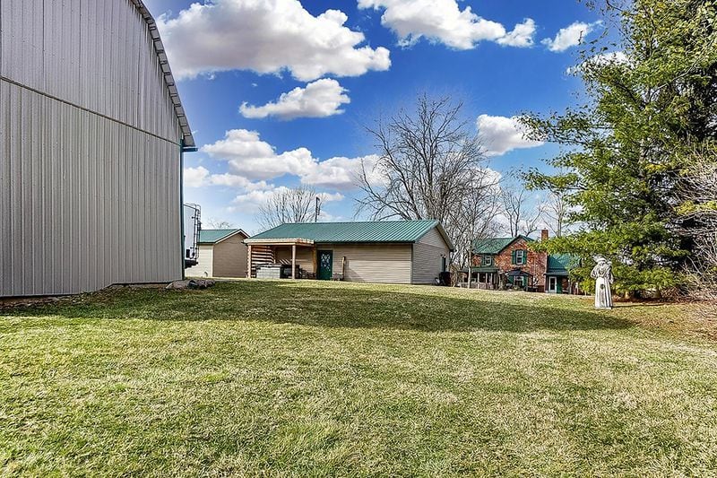 The rear of the home has a newer asphalt driveway leading to the detached garage, heated workshop and barn with chicken coup. CONTRIBUTED PHOTO