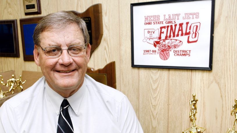 Jim Murray, retiring Northeastern Athletic Director, sits in his office among some of the many awards that Northeastern athletes have won over the years. Staff Photo by Barbara J. Perenic