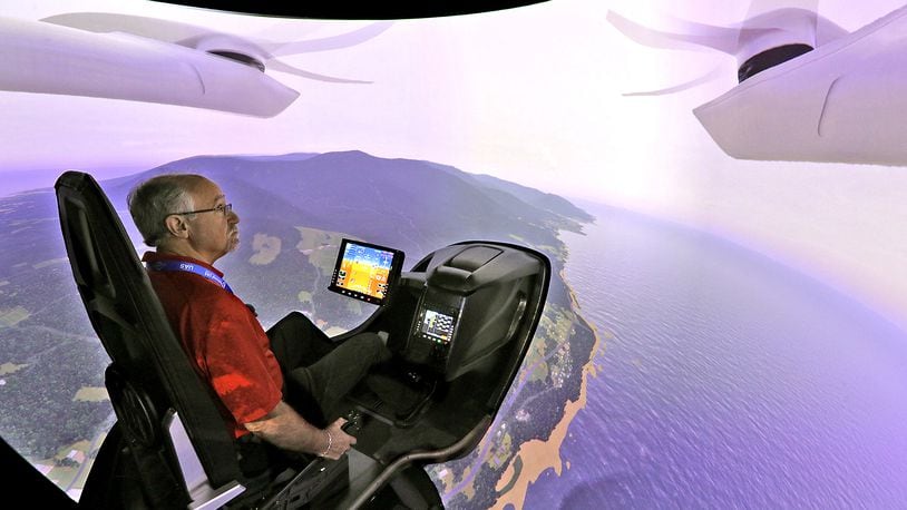 Joe Sciabica, from the Arctos company in Dayton, flies one of BETA Technologies flight simulators Tuesday, August 23, 2022 during the second day of the National Advanced Air Mobility Industry Forum at Springfield Beckley Municipal Airport. BILL LACKEY/STAFF