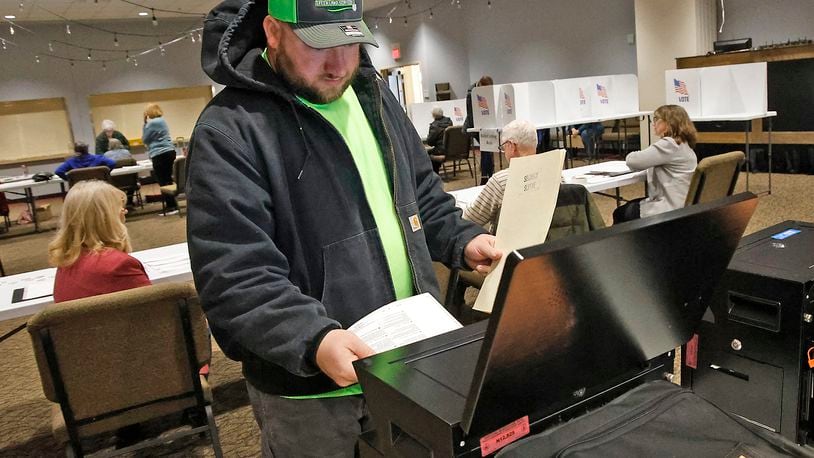Casey Tingley puts his ballot in the voting machine Tuesday, March 19, 2024 at the First Christian Church on Middle Urbana Road. BILL LACKEY/STAFF