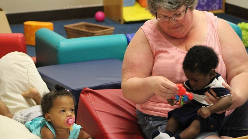 About 80 children are enrolled at the Miami View Head Start Center on West Fifth St. in Dayton. Lead teacher Mitzi Ochs is seen here with 14-month-old Javayah Matthews and 5-month-old Logan Brown. CORNELIUS FROLIK / STAFF