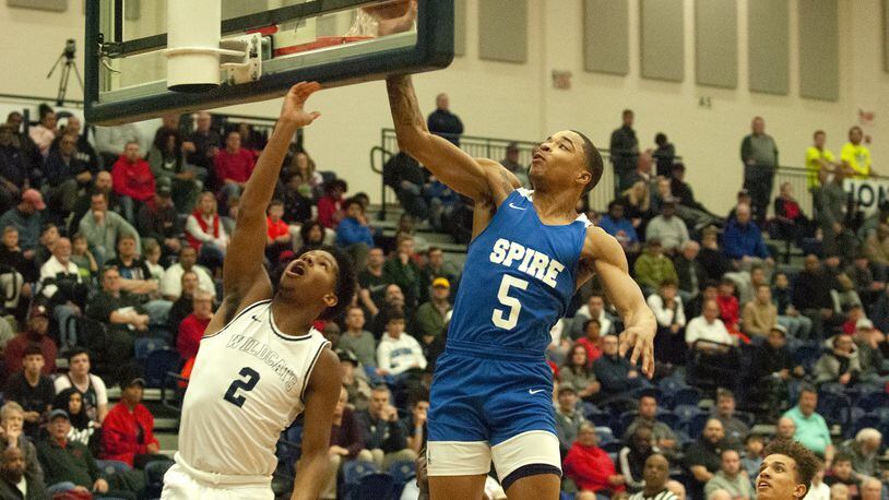 Spire Academy’s RaHeim Moss blocks a shot by former teammate Jalan Minney during Monday’s game at Flyin’ To The Hoop. Spire won 78-42 and Moss scored nine points. Jeff Gilbert/CONTRIBUTED