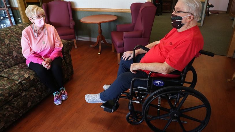 Peggy Derr visits with her husband, John, a patient at Villa of Springfield Wednesday. Villa started allowing visitation by appointments this week. BILL LACKEY/STAFF