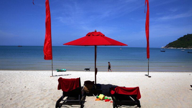 KOH PHANGAN THAILAND - JUNE 18:  A white sand beach decorated by red umbrellas at the Anantara Rasananda resort  June 18, 2012 on the island of Koh Phangan off the coast of Koh Samui . Thailand's official tourism body, the Tourism Authority of Thailand (TAT) has set itself the ambitious target of attracting more than 20 million tourists in 2012. According to TAT, In April, Thailand welcomed 1,659,021 international tourists which is a slight increase of 6.87% over the same in 2011.  (Photo by Paula Bronstein/Getty Images)