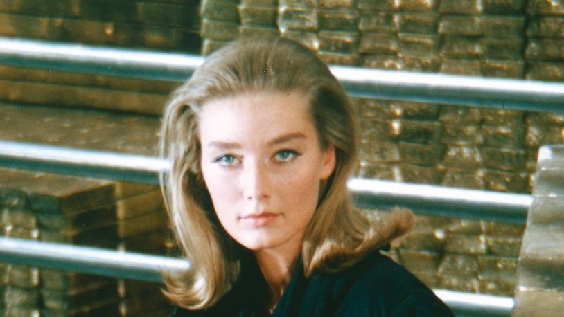 English actress Tania Mallet sits on a pile of gold bullion in Fort Knox, for her role as Tilly Masterson in 'Goldfinger', 1964. Mallet died in 2019 at age 77.