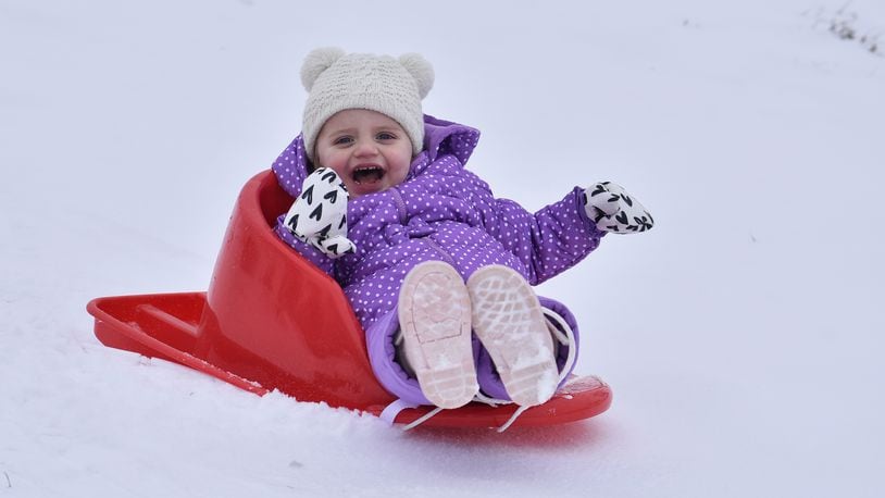 Emmie Colliver, 2, sleds down a hill at St. John XXIII Catholic School Monday, Feb. 15, 2021 in Middletown. NICK GRAHAM / STAFF