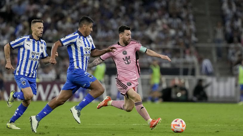 Inter Miami's Lionel Messi, right, tries control the ball past Monterrey's Luis Romo during a CONCACAF Champions Cup quarter final second leg soccer match at the BBVA stadium in Monterrey, Mexico, Wednesday, April 10, 2024. (AP Photo/Eduardo Verdugo)