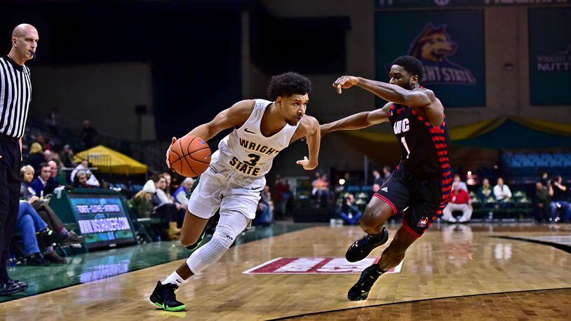 Wright State’s Mark Hughes tries to drive around UIC’s Marcus Ottey during Friday’s game at the Nutter Center. Josepth Craven/CONTRIBUTED