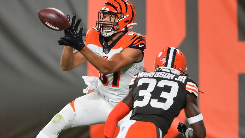 Cincinnati Bengals tight end C.J. Uzomah catches a touchdown pass next to Cleveland Browns' Ronnie Harrison Jr. during the first half of an NFL football game Thursday, Sept. 17, 2020, in Cleveland. (AP Photo/David Richard)