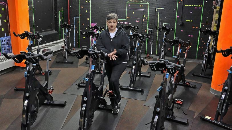 Pat Frock, owner of Springfield Health and Fitness, talks about the new spinning room she’s added recently. Springfield Health and Fitness has increased its membership by double. Bill Lackey/Staff