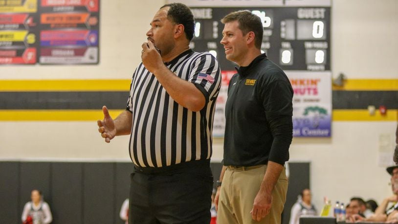 Shawnee High School coach Chris McGuire talks with an official during their game against Southeastern on Dec. 15, 2018. McGuire was recently honored for winning his 200th game at Shawnee. CONTRIBUTED PHOTO BY MICHAEL COOPER