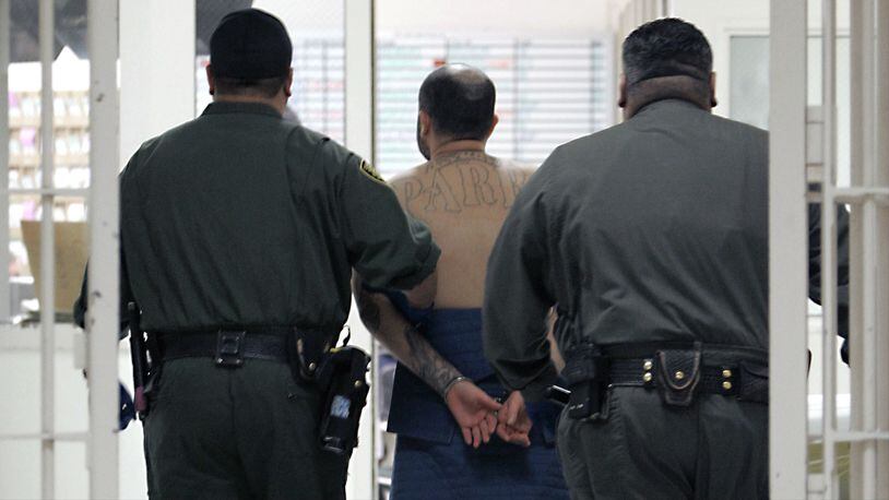 An inmate on suicide watch is escorted by correctional officers at the California Substance Abuse Treatment Facility in Corcoran in a January 2009 file photo. The chief psychiatrist for California's prison system alleged in a report made public Oct. 31, 2018, that state officials have provided inaccurate or misleading information to a federal judge and inmates' attorneys, giving the false impression that the system is properly caring for mentally ill inmates. U.S. District Judge Kimberly Mueller, who oversees mental health care in California's prisons as part of an ongoing federal lawsuit, said she plans to hear public testimony from the whistleblower.